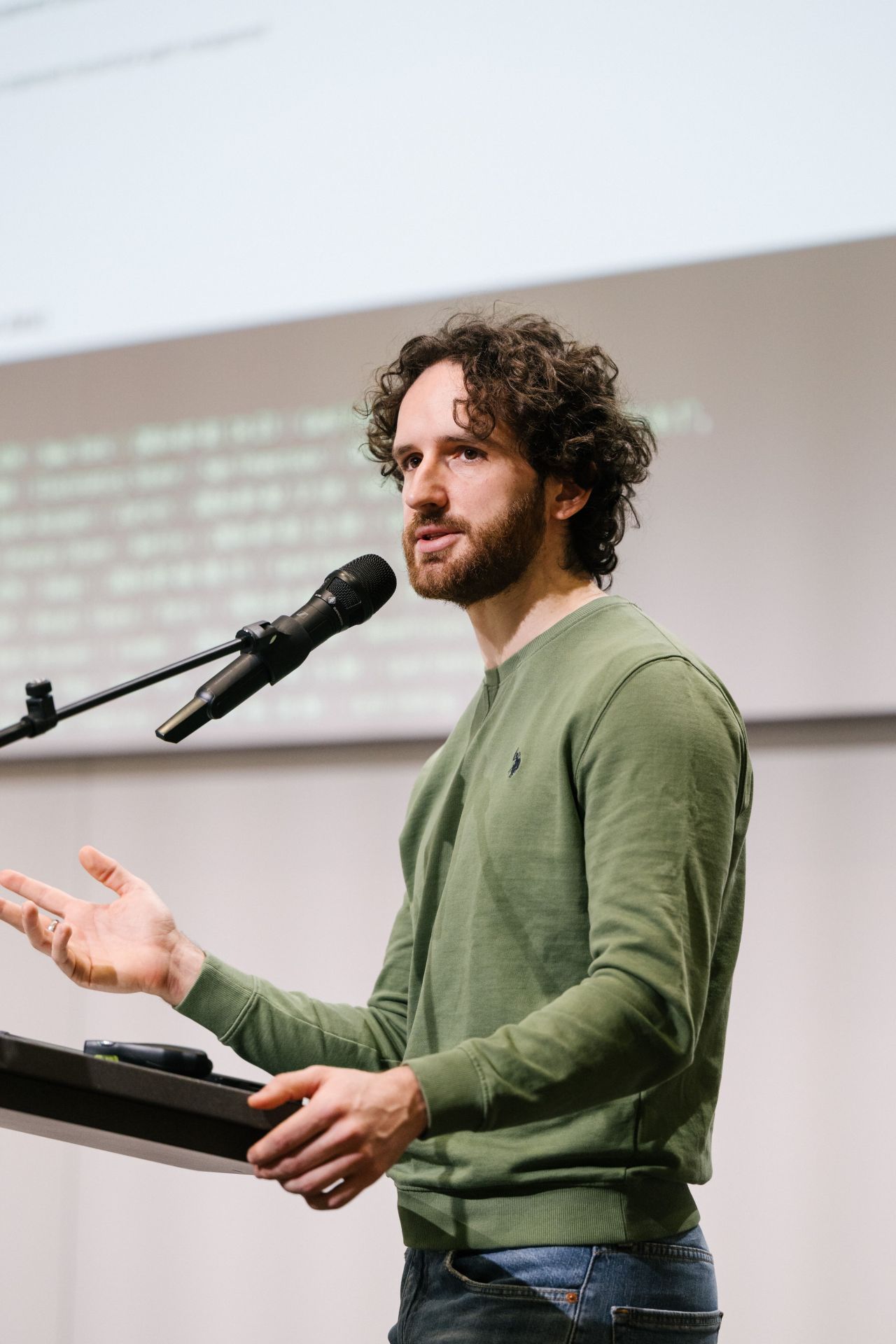 Alessandro Romano speaking on stage